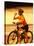 Young Woman Drinking Water Sitting on a Bicycle-null-Stretched Canvas