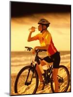 Young Woman Drinking Water Sitting on a Bicycle-null-Mounted Photographic Print