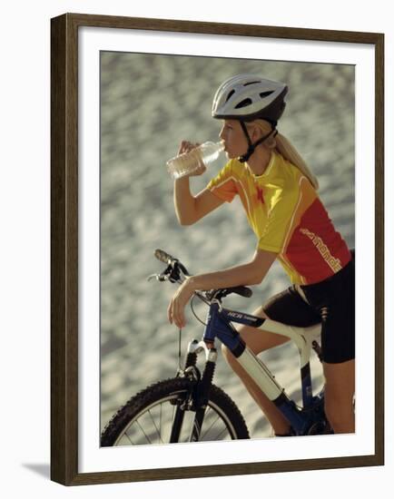 Young Woman Drinking Water While Sitting on a Bicycle-null-Framed Premium Photographic Print