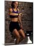 Young Woman Exercising on a Stationary Bike Checking her Heart Rate-null-Mounted Photographic Print