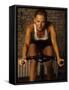 Young Woman Exercising on a Stationary Bike-null-Framed Stretched Canvas