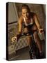 Young Woman Exercising on a Stationary Bike-null-Stretched Canvas