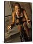 Young Woman Exercising on a Stationary Bike-null-Stretched Canvas