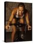 Young Woman Exercising on a Stationary Bike-null-Stretched Canvas