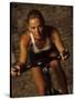 Young Woman Exercising on a Stationary Bike-null-Stretched Canvas