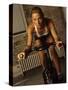 Young Woman Exercising on a Stationary Bike-null-Stretched Canvas