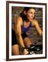 Young Woman Exercising on a Stationary Bike-null-Framed Photographic Print