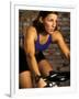 Young Woman Exercising on a Stationary Bike-null-Framed Photographic Print