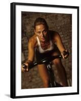 Young Woman Exercising on a Stationary Bike-null-Framed Photographic Print