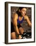 Young Woman Exercising on a Stationary Bike-null-Framed Photographic Print