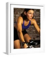 Young Woman Exercising on a Stationary Bike-null-Framed Photographic Print