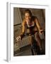 Young Woman Exercising on a Stationary Bike-null-Framed Photographic Print