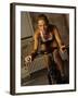 Young Woman Exercising on a Stationary Bike-null-Framed Photographic Print