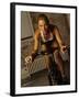 Young Woman Exercising on a Stationary Bike-null-Framed Photographic Print