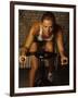 Young Woman Exercising on a Stationary Bike-null-Framed Photographic Print