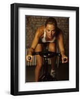 Young Woman Exercising on a Stationary Bike-null-Framed Photographic Print