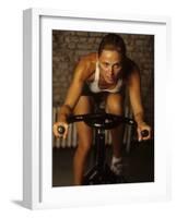 Young Woman Exercising on a Stationary Bike-null-Framed Photographic Print