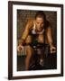 Young Woman Exercising on a Stationary Bike-null-Framed Photographic Print