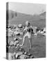 Young Woman Hiking Through a Stream of Water-null-Stretched Canvas