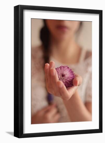 Young Woman Holding a Small Pink Flower-Carolina Hernandez-Framed Photographic Print