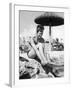 Young Woman in a Bikini Prepares to Go Snorkelling by Putting on Her Rubber Flippers-null-Framed Photographic Print