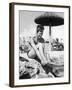 Young Woman in a Bikini Prepares to Go Snorkelling by Putting on Her Rubber Flippers-null-Framed Photographic Print