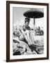 Young Woman in a Bikini Prepares to Go Snorkelling by Putting on Her Rubber Flippers-null-Framed Photographic Print