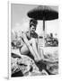 Young Woman in a Bikini Prepares to Go Snorkelling by Putting on Her Rubber Flippers-null-Framed Photographic Print