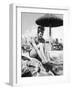 Young Woman in a Bikini Prepares to Go Snorkelling by Putting on Her Rubber Flippers-null-Framed Photographic Print