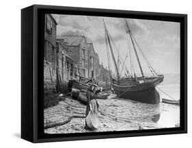 Young Woman in Headscarf and Working Clothes Looks out to Sea from the Shoreline-null-Framed Stretched Canvas