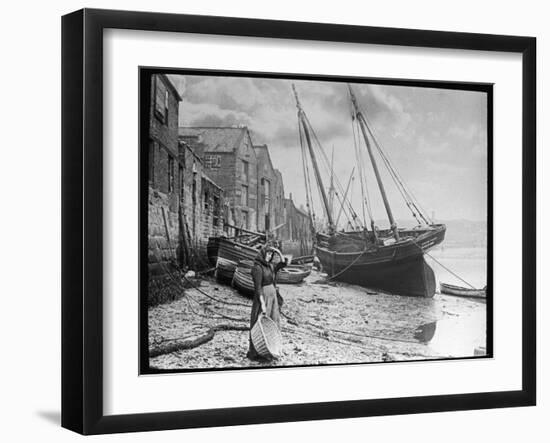 Young Woman in Headscarf and Working Clothes Looks out to Sea from the Shoreline-null-Framed Photographic Print