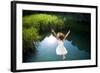 Young Woman in White Dress Jumping into a Idyllic Lake-Luna Vandoorne-Framed Photographic Print
