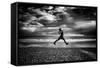 Young Woman Jumping on Beach-Rory Garforth-Framed Stretched Canvas