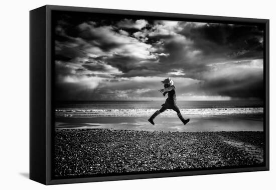 Young Woman Jumping on Beach-Rory Garforth-Framed Stretched Canvas