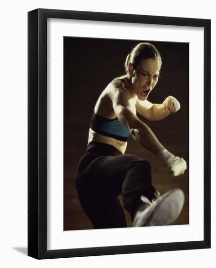 Young Woman Kickboxing-null-Framed Photographic Print