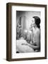 Young Woman Looking into a Mirror and Putting on Make Up-null-Framed Photo