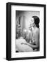 Young Woman Looking into a Mirror and Putting on Make Up-null-Framed Photo