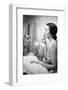 Young Woman Looking into a Mirror and Putting on Make Up-null-Framed Photo