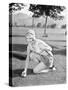 Young Woman on a Golf Course Placing a Golf Ball-null-Stretched Canvas