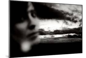 Young Woman Out of Focus in Front of Cloudy Sky Looking into the Camera-Torsten Richter-Mounted Photographic Print