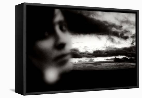 Young Woman Out of Focus in Front of Cloudy Sky Looking into the Camera-Torsten Richter-Framed Stretched Canvas