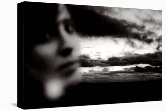 Young Woman Out of Focus in Front of Cloudy Sky Looking into the Camera-Torsten Richter-Stretched Canvas