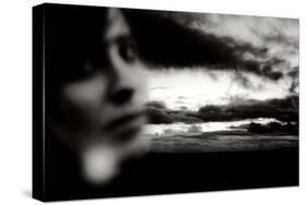 Young Woman Out of Focus in Front of Cloudy Sky Looking into the Camera-Torsten Richter-Stretched Canvas