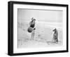 Young Woman Playing with Her Dog and Ball on the Beach-null-Framed Photo