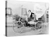 Young Woman Sitting on a Car Holding a Big Heart Shaped Sign-null-Stretched Canvas