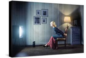 Young Woman Sitting on a Chair in Vintage Interior and Watching Retro TV-viczast-Stretched Canvas