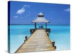 Young Woman Sitting on Bench at the End of Jetty, Maldives, Indian Ocean-Papadopoulos Sakis-Stretched Canvas