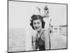 Young Woman Smiles and Sits on a Swimming Pier, Ca. 1938-null-Mounted Photographic Print