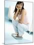 Young Woman, Squatting on Scales, Chin in Hand-null-Mounted Photographic Print