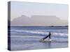 Young Woman Surfer Enters the Water of the Atlantic Ocean with Table Mountain in the Background-Yadid Levy-Stretched Canvas